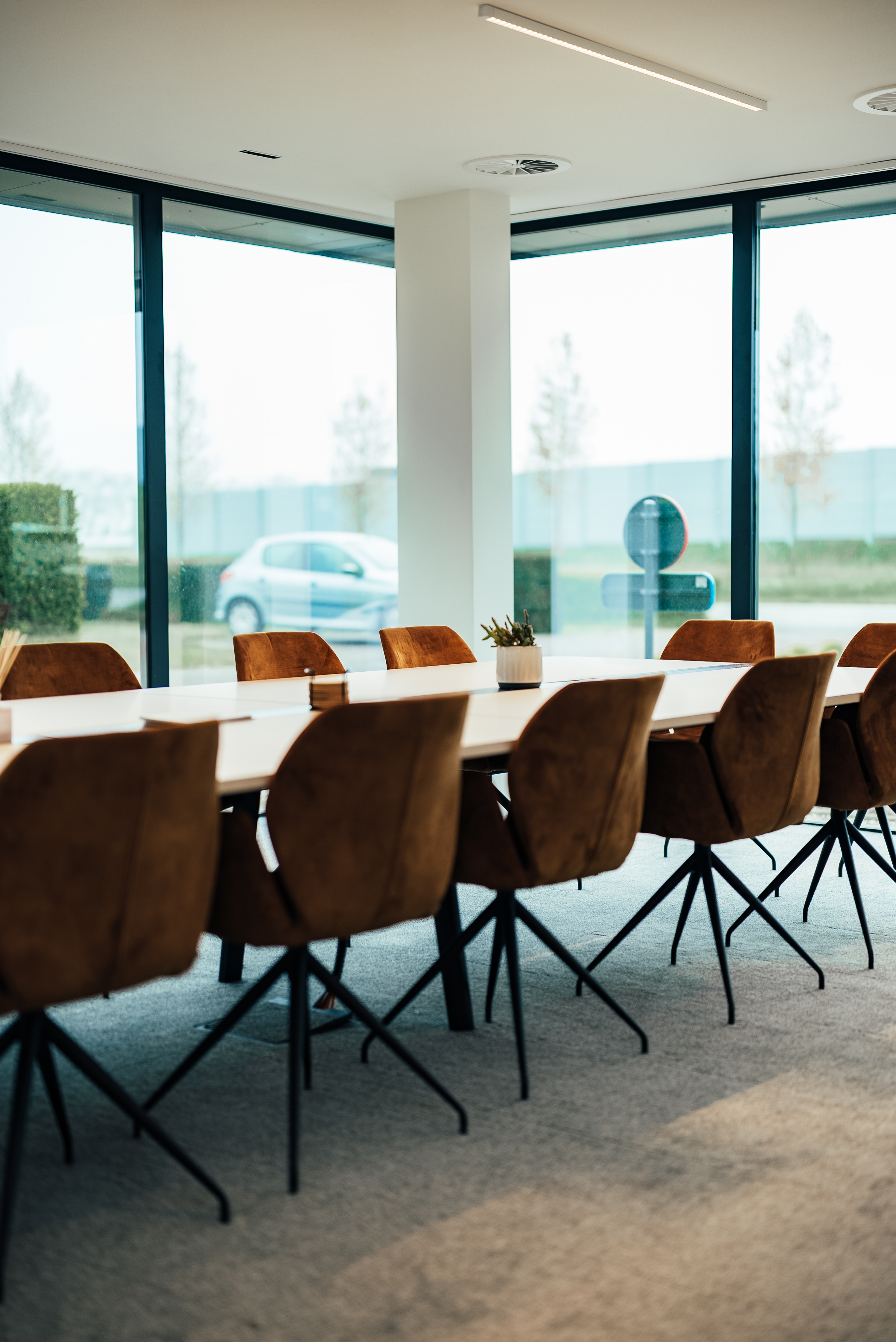 The Boardroom at BORA, fourteen-seat walnut table with cognac chairs